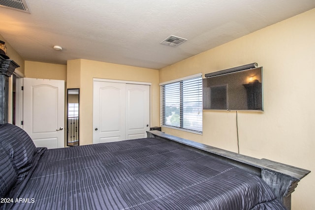 unfurnished bedroom featuring a closet and a textured ceiling