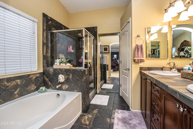 bathroom featuring vanity and independent shower and bath