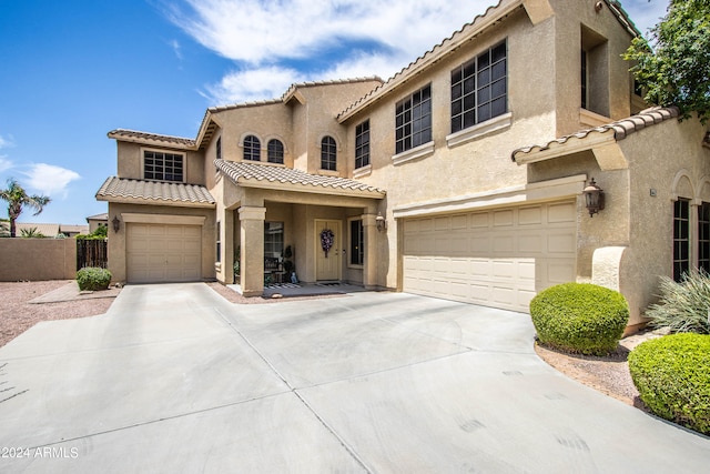 mediterranean / spanish-style home with a garage