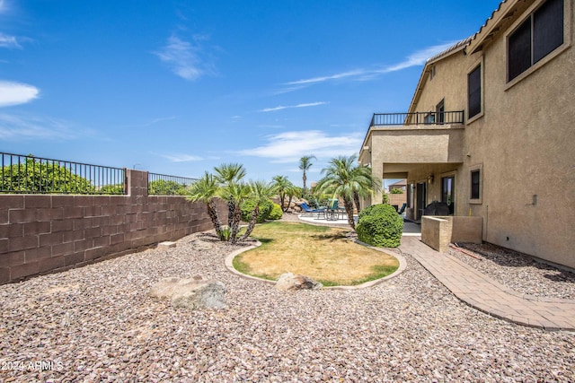 view of yard featuring a patio area and a balcony