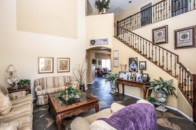 living room featuring a high ceiling