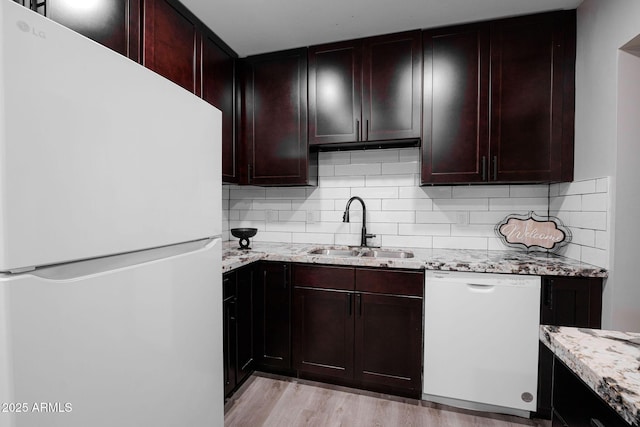 6130 N 27th Ave, Phoenix, AZ 85017 - kitchen with a sink, white appliances, light wood finished floors, backsplash, and light stone counters