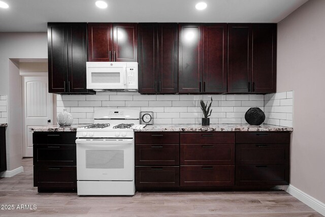 6130 N 27th Ave, Phoenix, AZ 85017 - kitchen with tasteful backsplash, white appliances, light wood-style flooring, and baseboards