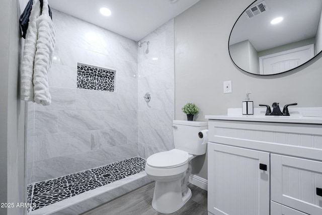 6130 N 27th Ave, Phoenix, AZ 85017 - full bathroom featuring tiled shower, vanity, toilet, and wood finished floors