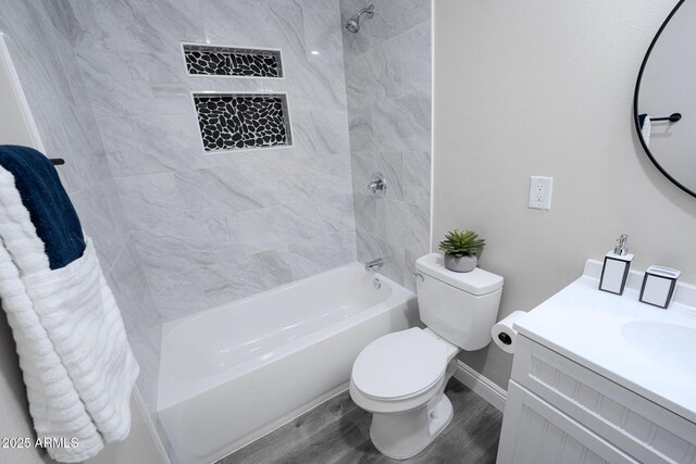 6130 N 27th Ave, Phoenix, AZ 85017 - full bath with baseboards, toilet, bathtub / shower combination, vanity, and wood finished floors