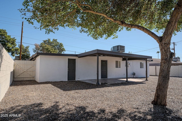 6130 N 27th Ave, Phoenix, AZ 85017 - rear view of house with a patio, central air condition unit, stucco siding, a fenced backyard, and a gate