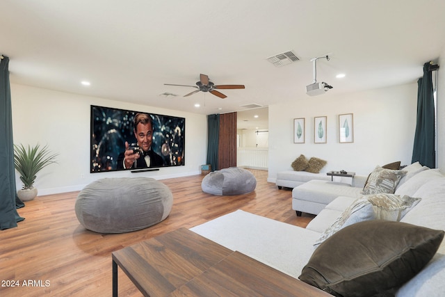 living room with ceiling fan and light hardwood / wood-style flooring