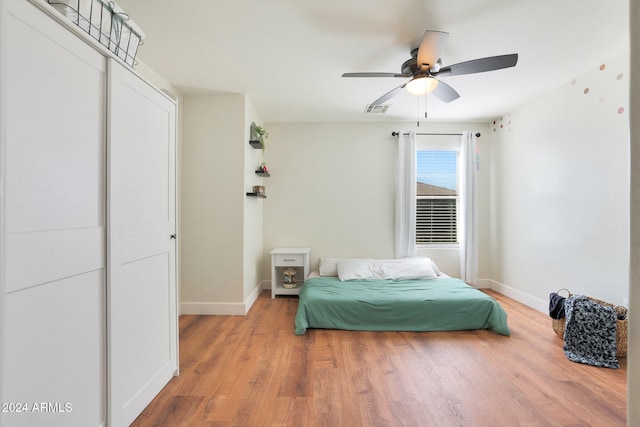 bedroom with a closet, ceiling fan, and wood-type flooring