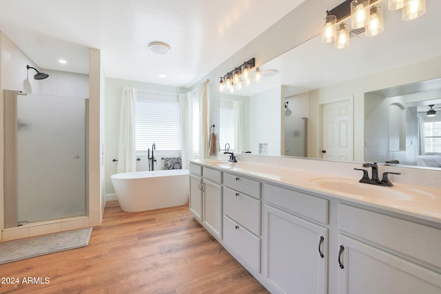 bathroom with vanity, wood-type flooring, and separate shower and tub