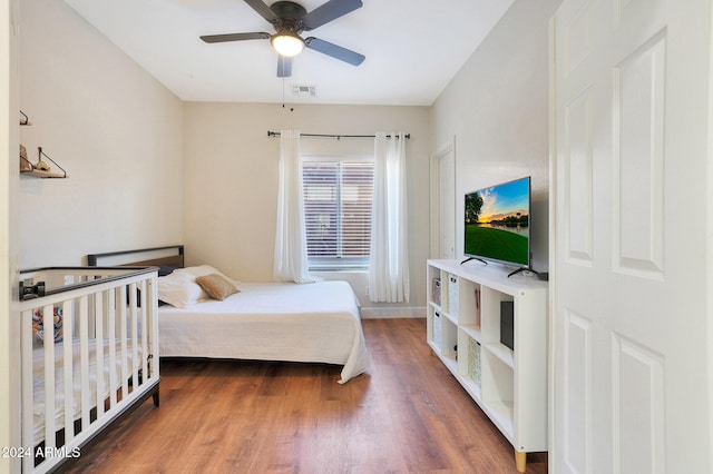 bedroom with hardwood / wood-style flooring and ceiling fan