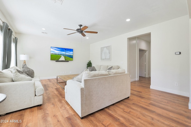 living room featuring light wood-type flooring and ceiling fan