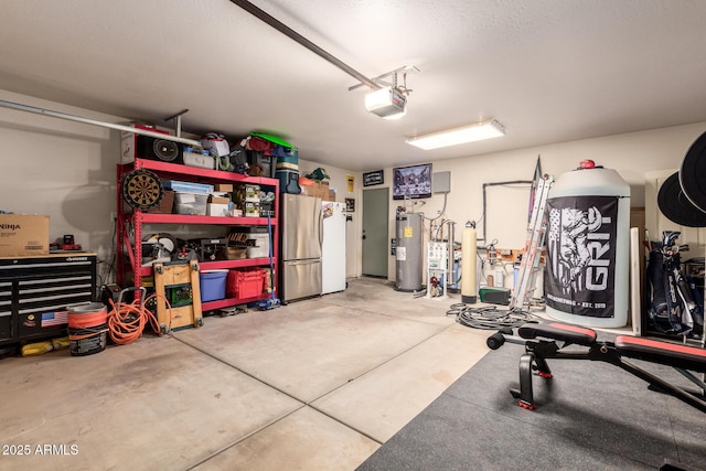 4621 S 179th Dr, Goodyear, AZ 85338 - garage featuring a garage door opener, electric water heater, and freestanding refrigerator