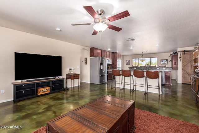4621 S 179th Dr, Goodyear, AZ 85338 - living room with finished concrete floors, ceiling fan, recessed lighting, and a barn door