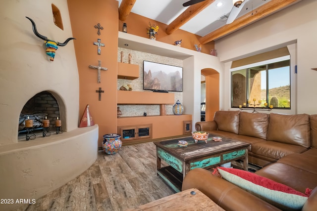 living room with beamed ceiling, hardwood / wood-style flooring, and ceiling fan