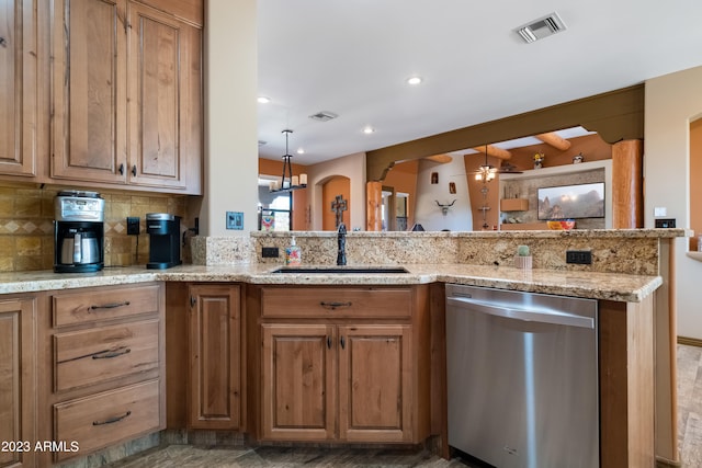 kitchen with sink, tasteful backsplash, stainless steel dishwasher, kitchen peninsula, and light stone countertops