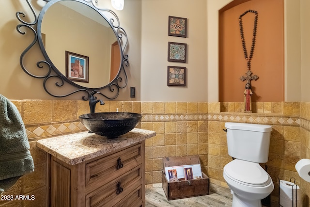 bathroom featuring hardwood / wood-style flooring, vanity, tile walls, and toilet