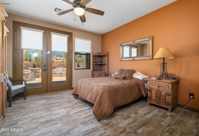 bedroom with access to exterior, hardwood / wood-style floors, french doors, and ceiling fan