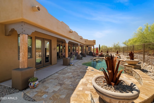 view of patio / terrace featuring french doors and a fenced in pool