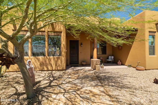 entrance to property with a patio