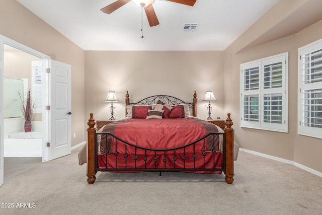 bedroom featuring visible vents, carpet floors, baseboards, and ensuite bath