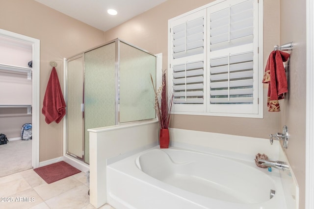 bathroom with tile patterned flooring, baseboards, recessed lighting, a stall shower, and a bath