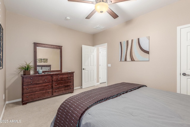 carpeted bedroom with visible vents, a ceiling fan, and baseboards