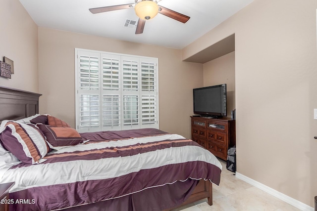 bedroom featuring light tile patterned floors, visible vents, ceiling fan, and baseboards