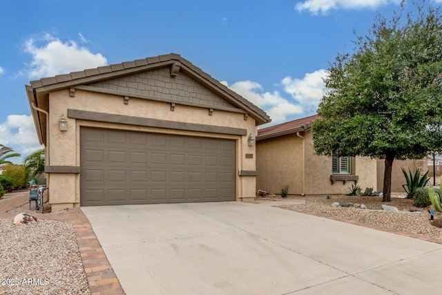 ranch-style home featuring stucco siding, a garage, and concrete driveway