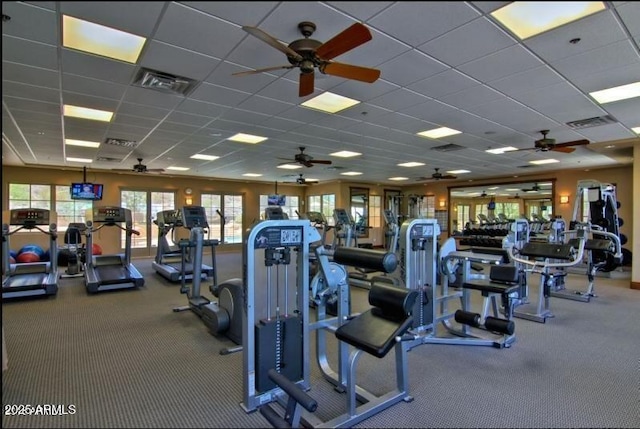 gym featuring visible vents, a drop ceiling, and ceiling fan