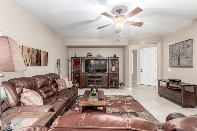 living area featuring baseboards and ceiling fan