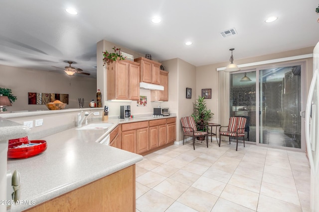 kitchen featuring a ceiling fan, visible vents, recessed lighting, a sink, and light countertops