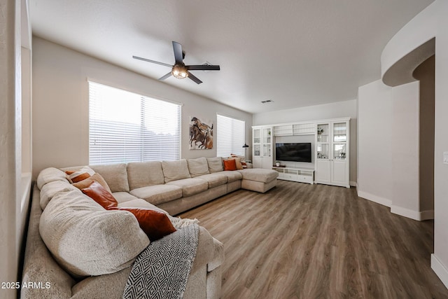 living room with wood-type flooring and ceiling fan