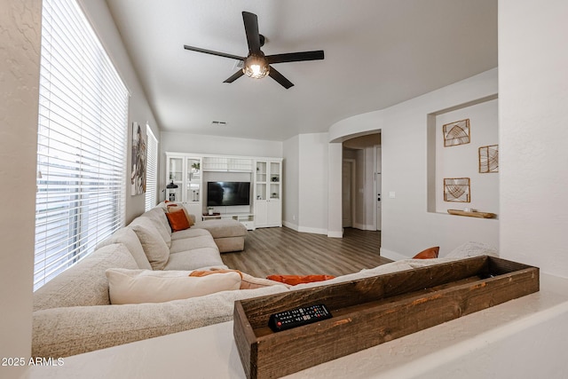 living room featuring wood-type flooring and ceiling fan