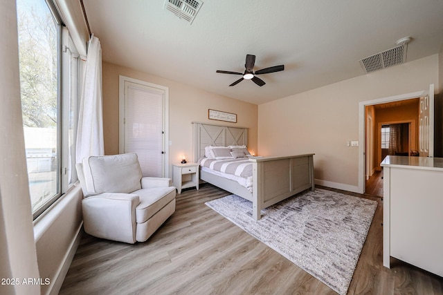 bedroom with ceiling fan and light hardwood / wood-style flooring