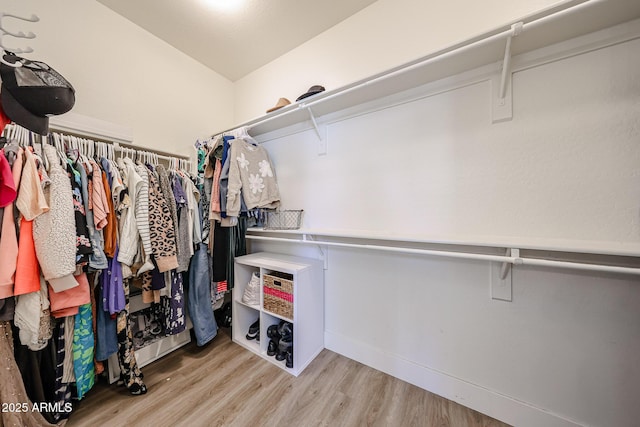 spacious closet with light hardwood / wood-style floors