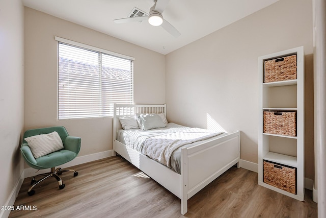 bedroom featuring ceiling fan and light hardwood / wood-style flooring