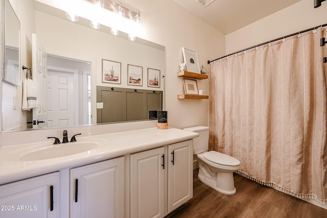 bathroom featuring hardwood / wood-style flooring, vanity, and toilet