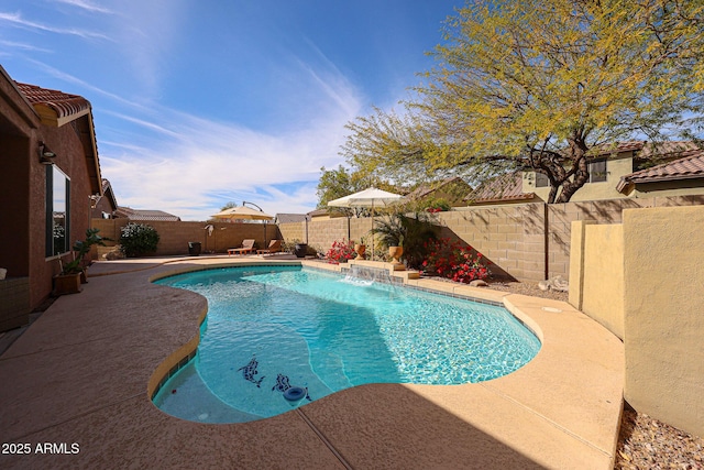 view of swimming pool featuring pool water feature and a patio area