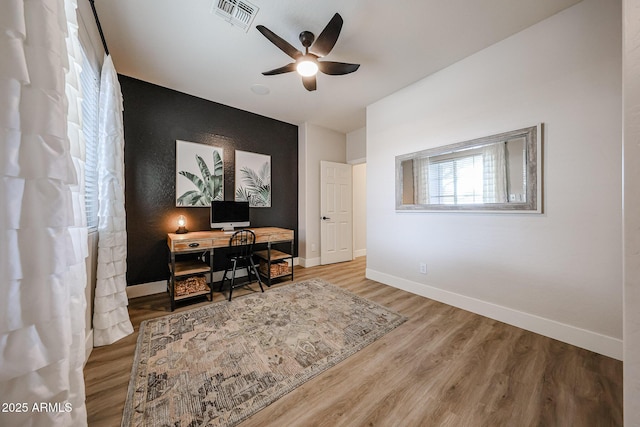 office featuring wood-type flooring and ceiling fan