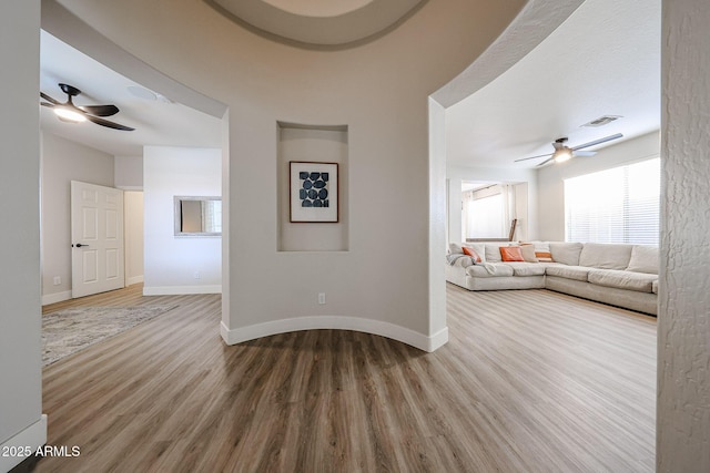 unfurnished living room with hardwood / wood-style floors and ceiling fan