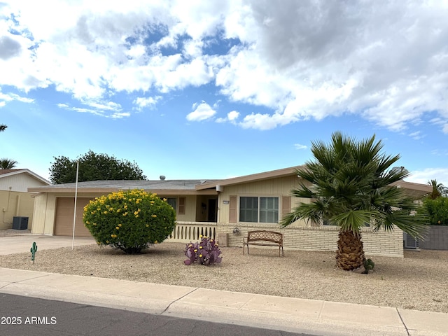 11044 W Cheryl Dr, Sun City, AZ 85351 - view of front of house featuring a garage, driveway, and cooling unit