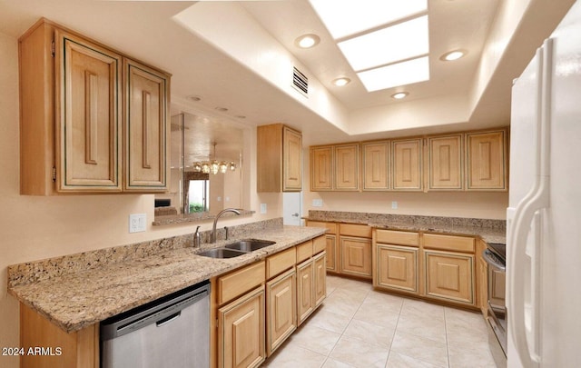 kitchen with sink, a raised ceiling, light brown cabinetry, light tile patterned floors, and appliances with stainless steel finishes