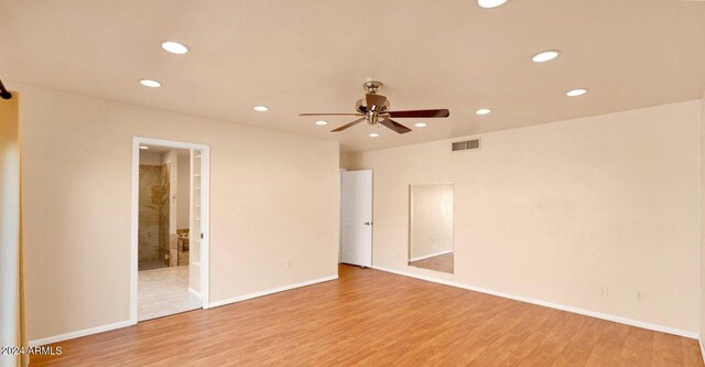 spare room with ceiling fan and light hardwood / wood-style floors