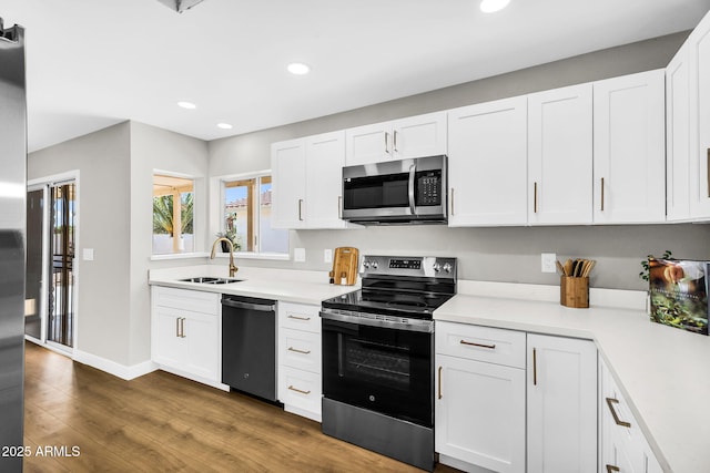 25810 S Boxwood Dr, Sun Lakes, AZ 85248 - kitchen with stainless steel appliances, a sink, white cabinetry, wood finished floors, and recessed lighting