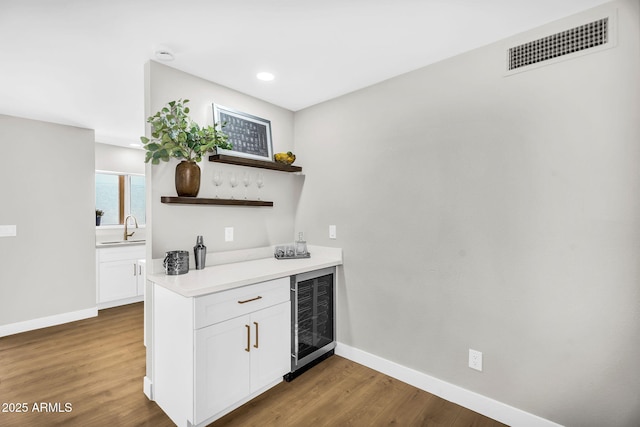 25810 S Boxwood Dr, Sun Lakes, AZ 85248 - indoor dry bar featuring wine cooler, baseboards, wood finished floors, and recessed lighting