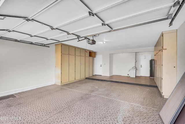 25810 S Boxwood Dr, Sun Lakes, AZ 85248 - garage with a garage door opener, baseboards, and water heater