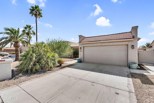 25810 S Boxwood Dr, Sun Lakes, AZ 85248 - view of front of home featuring a tiled roof, driveway, stucco siding, and a garage