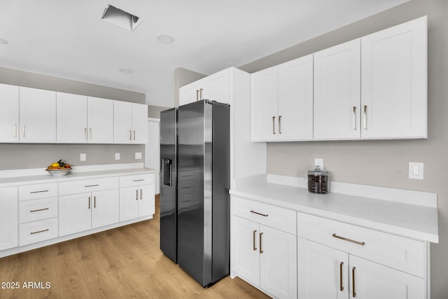 25810 S Boxwood Dr, Sun Lakes, AZ 85248 - kitchen featuring stainless steel refrigerator with ice dispenser, light countertops, white cabinets, and light wood-style floors