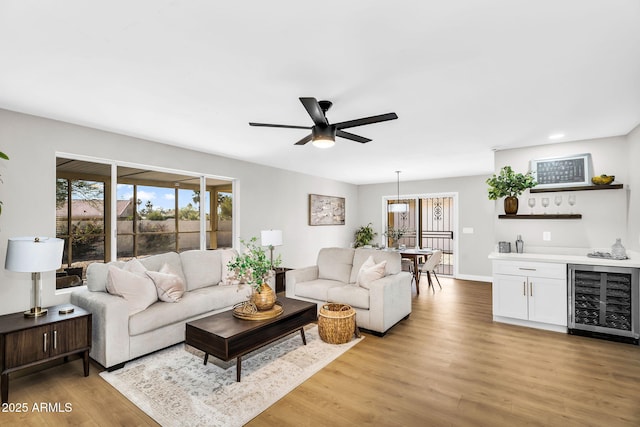 25810 S Boxwood Dr, Sun Lakes, AZ 85248 - living room featuring wine cooler, healthy amount of natural light, light wood finished floors, and a ceiling fan
