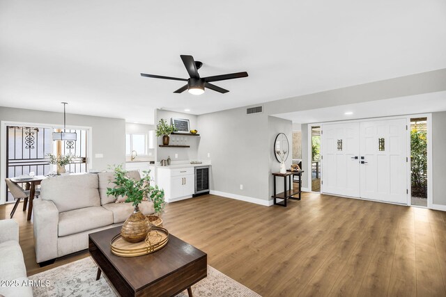 25810 S Boxwood Dr, Sun Lakes, AZ 85248 - living room with wine cooler, wood finished floors, baseboards, a ceiling fan, and recessed lighting